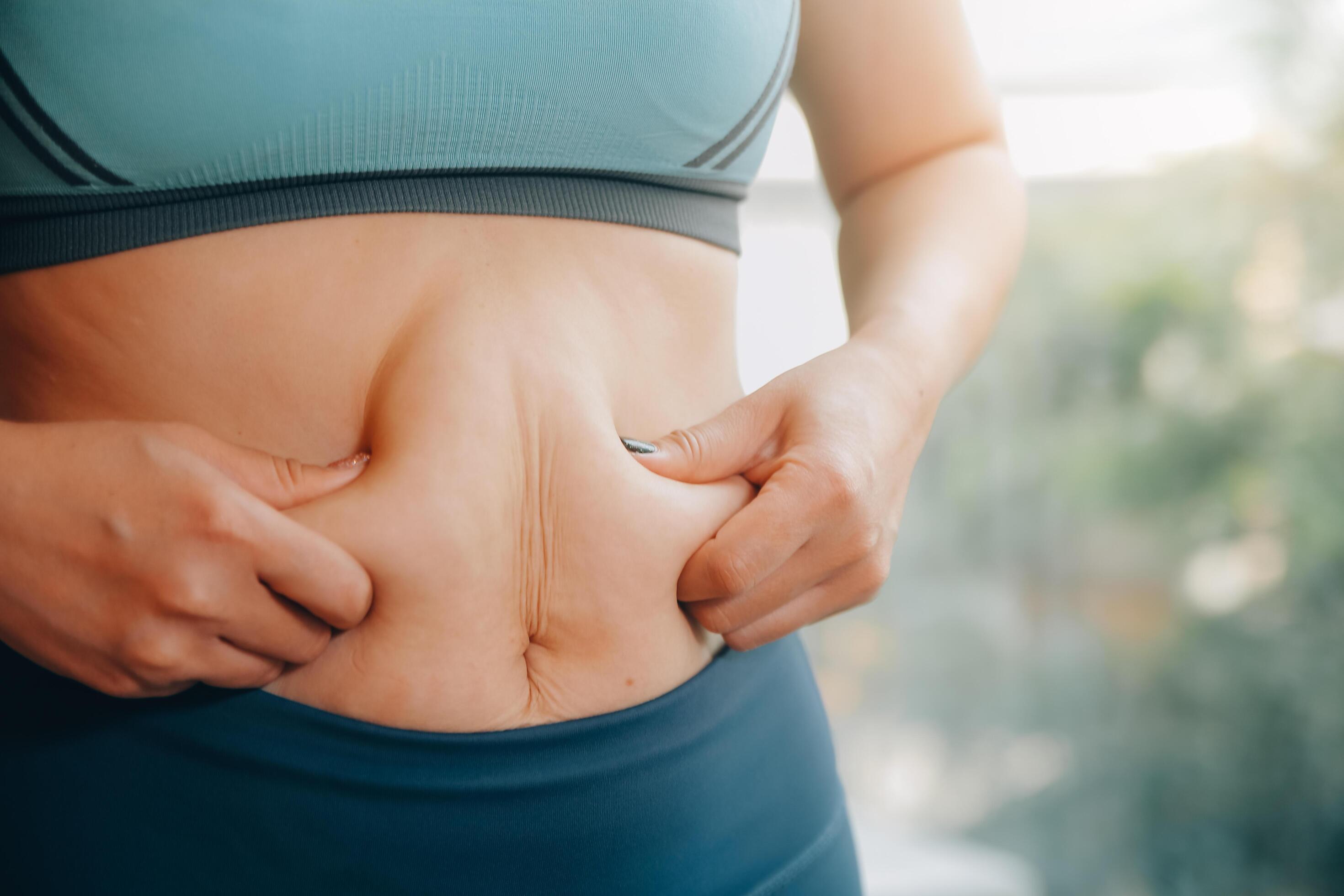 fat woman, fat belly, chubby, obese woman hand holding excessive belly fat with measure tape, woman diet lifestyle concept Stock Free