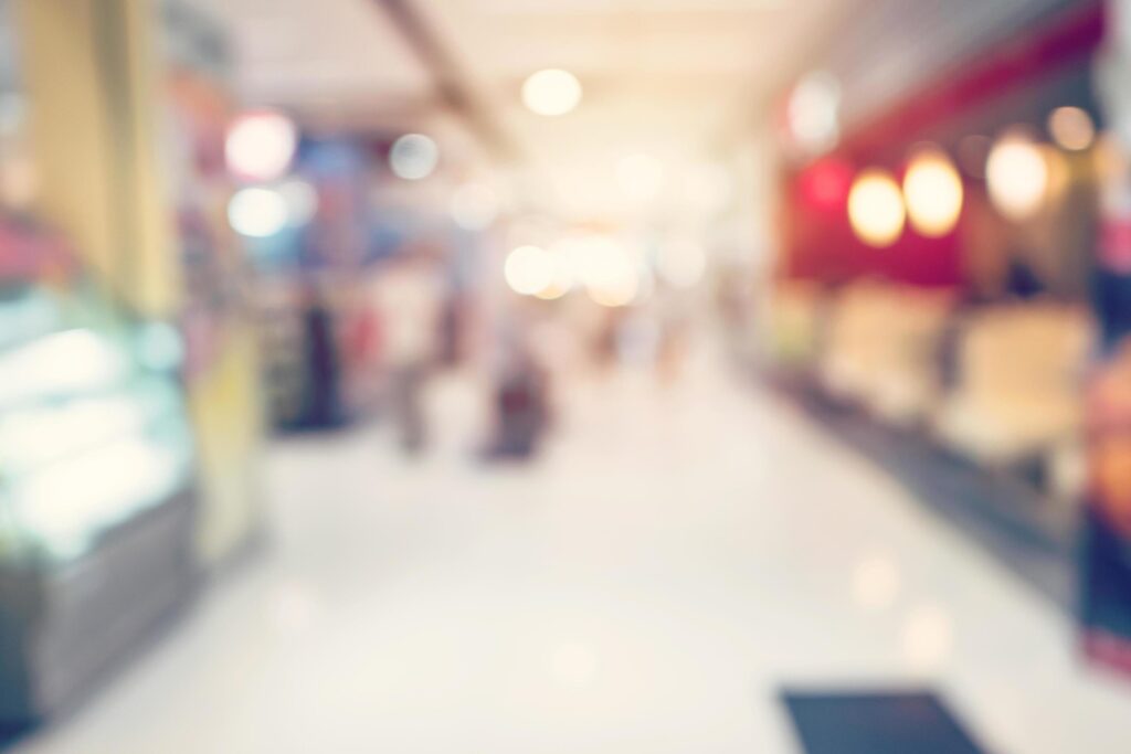 People shopping in department store. Defocused blur background.People shopping in department store Defocused blur background. Stock Free