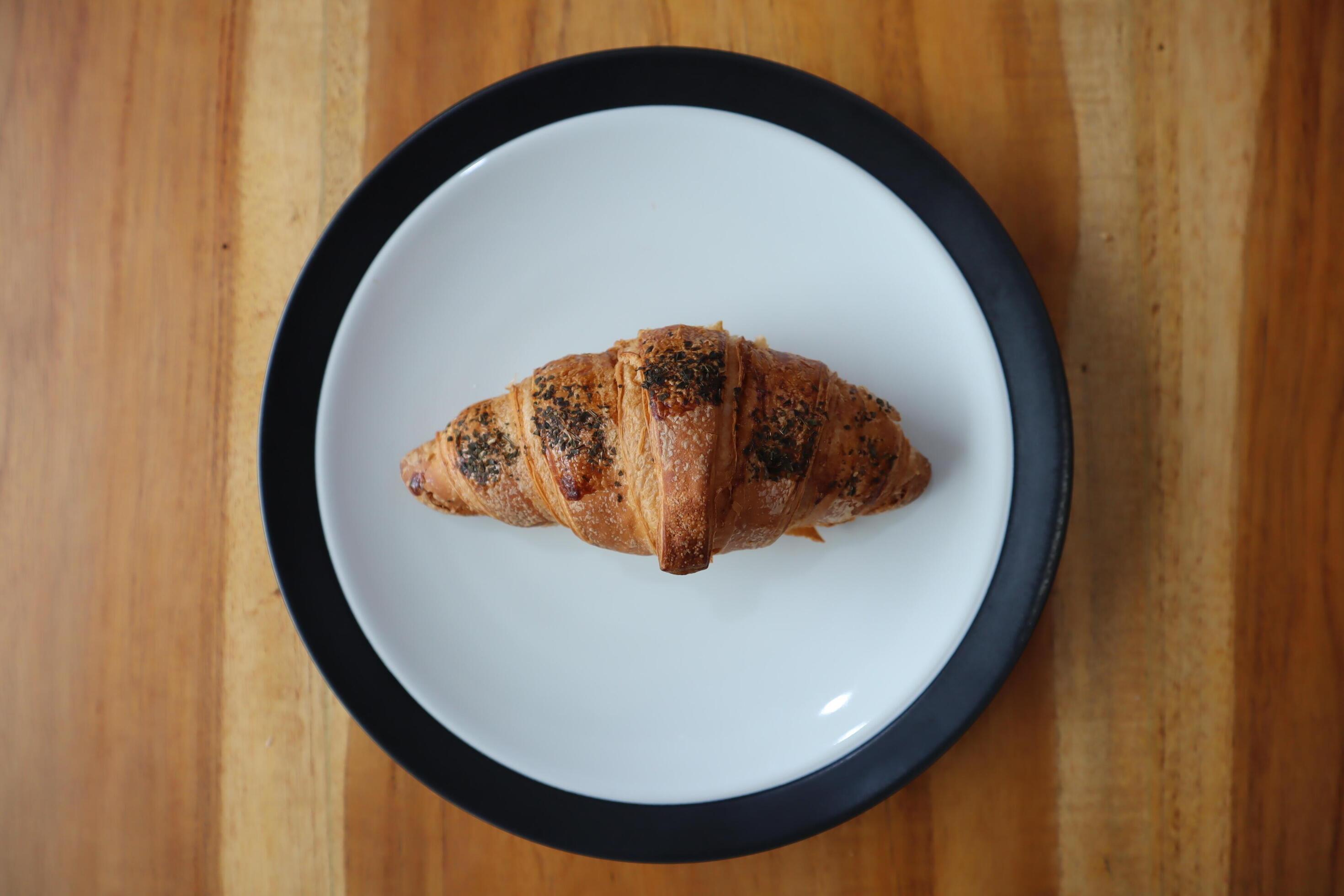 A plate of smoked beef croissants on the table background Stock Free