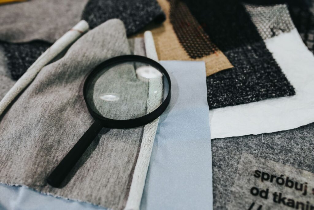 Magnifying glass with fabric on a table Stock Free