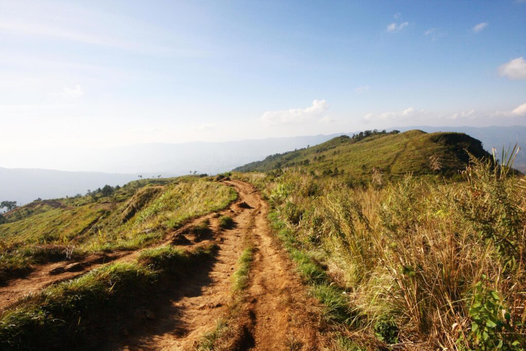 Natural footpath and dry grassland on the mountain with blue sky at Phu Chee Fah hill northern of Thailand Stock Free