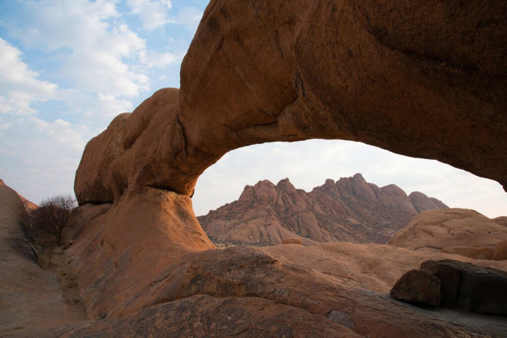 Beautiful landscape with a natural stone arch in Damaraland, Namibia. No people. Stock Free