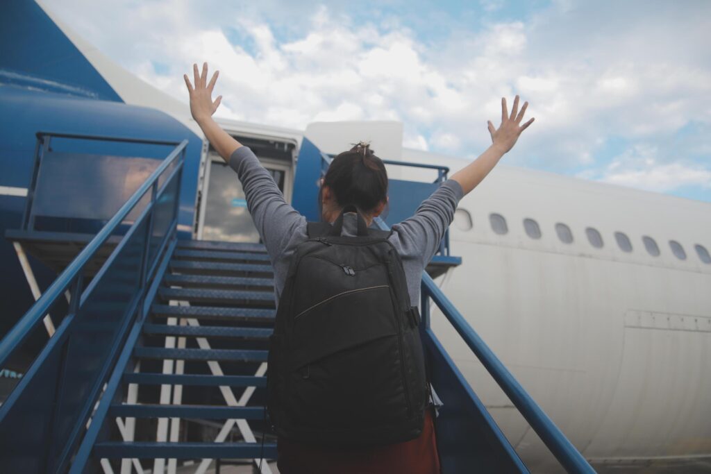 Happy attractive asian woman traveler with backpack at the modern airport terminal, copy space, Tourist journey trip concept Stock Free