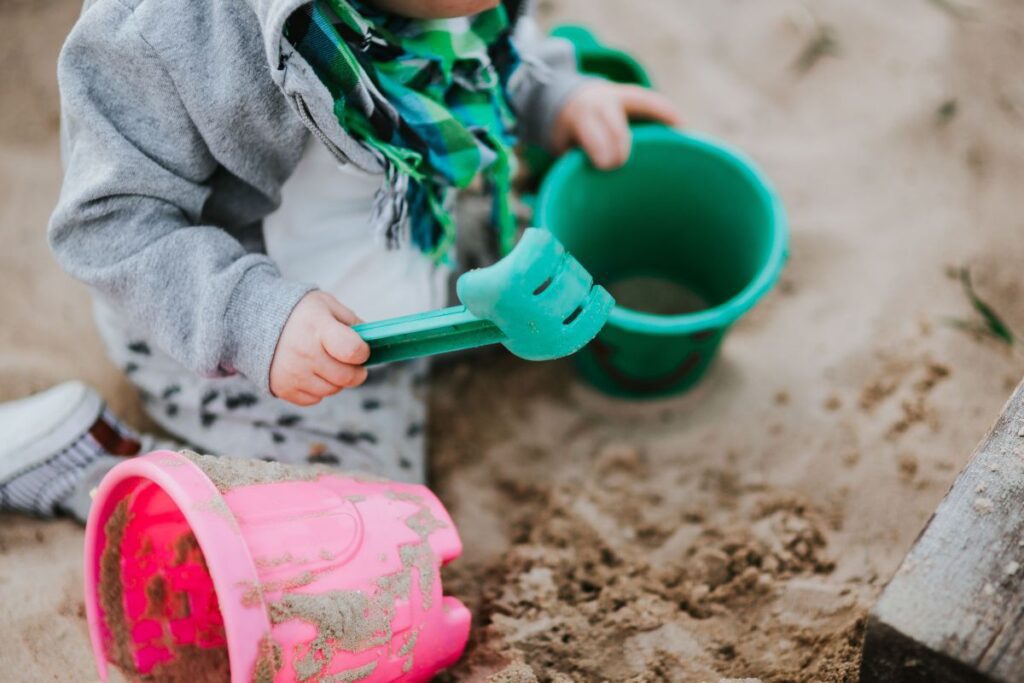 
									Toddler playing in the sand Stock Free