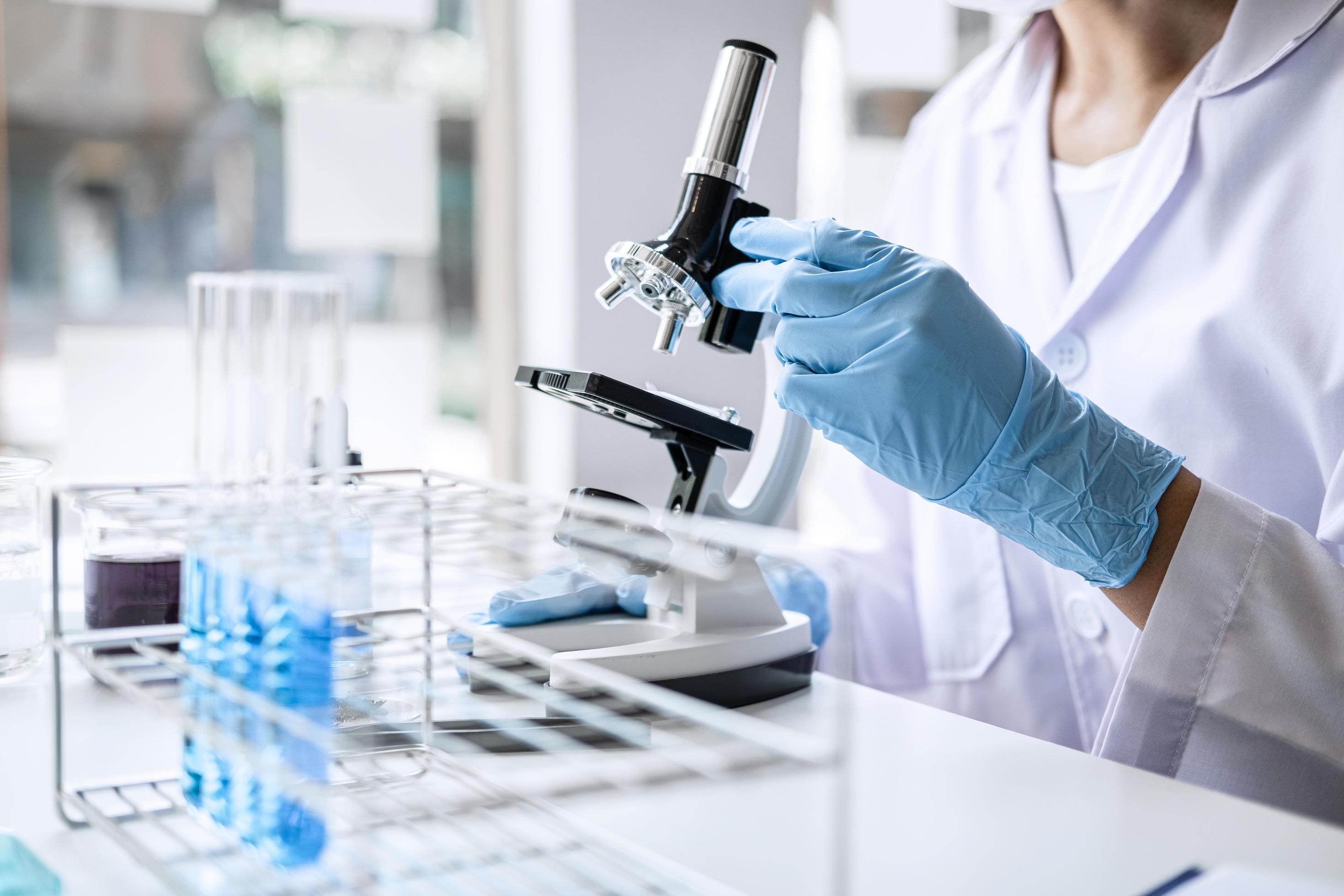 Close-up of a scientist with a microscope Stock Free