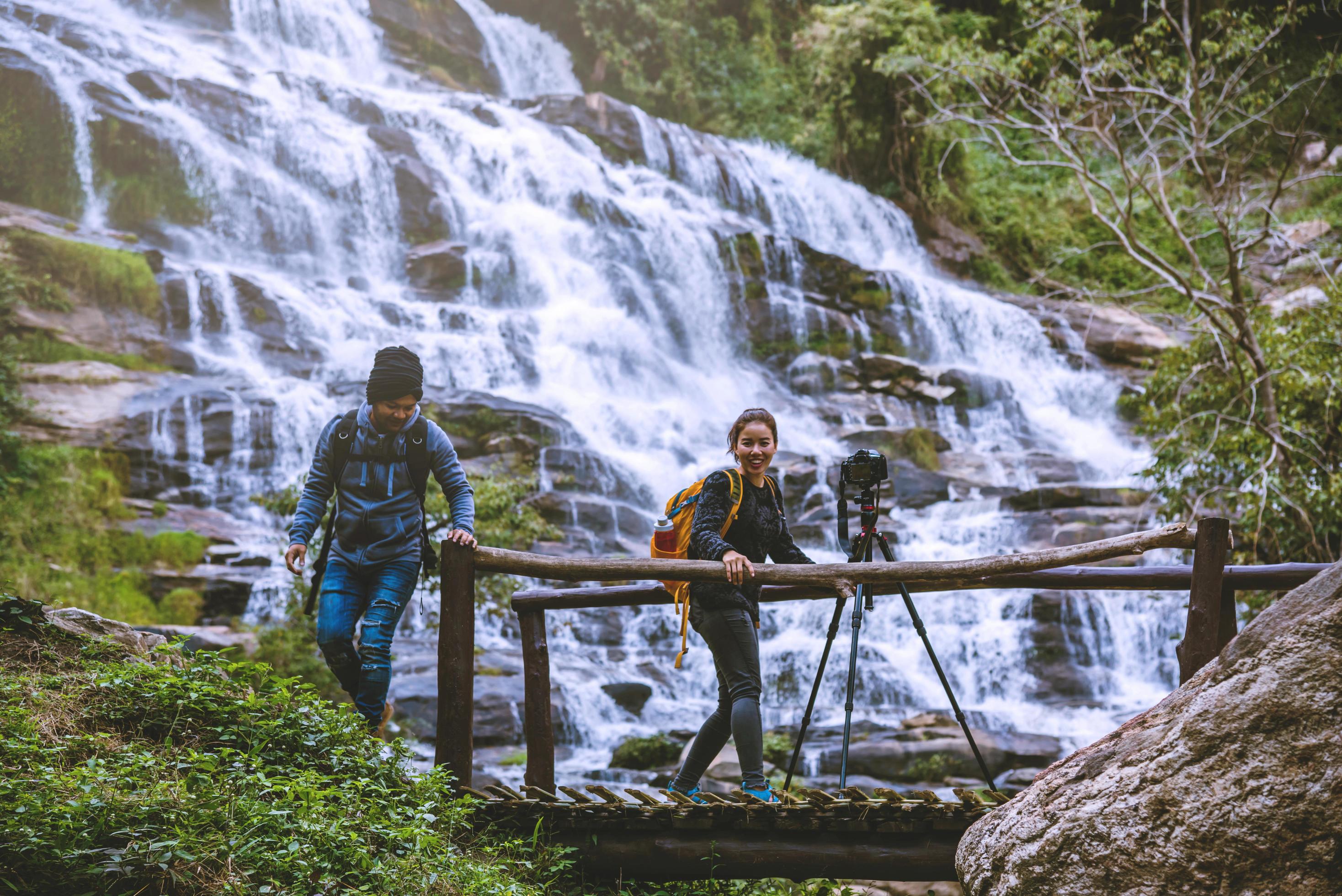 couples travel relax to photograph the waterfalls beautiful. In the winter. at the waterfall mae ya chiangmai in thailand. travel nature. summer Stock Free