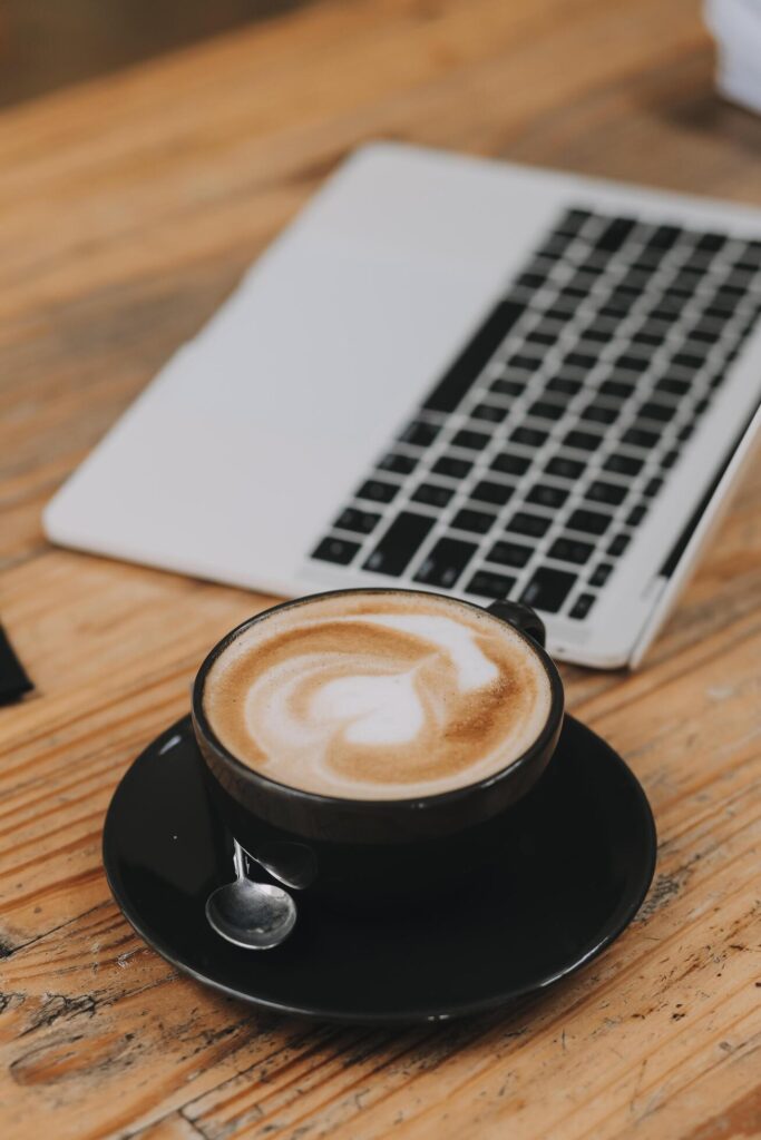 Closeup of coffee cup on table in empty corporate conference room before business meeting in office Stock Free