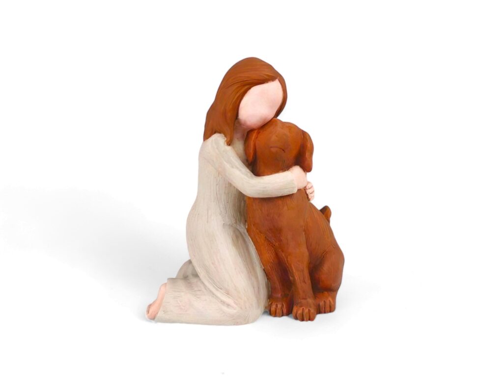 wooden miniature of a woman hugging a dog on a white background Stock Free