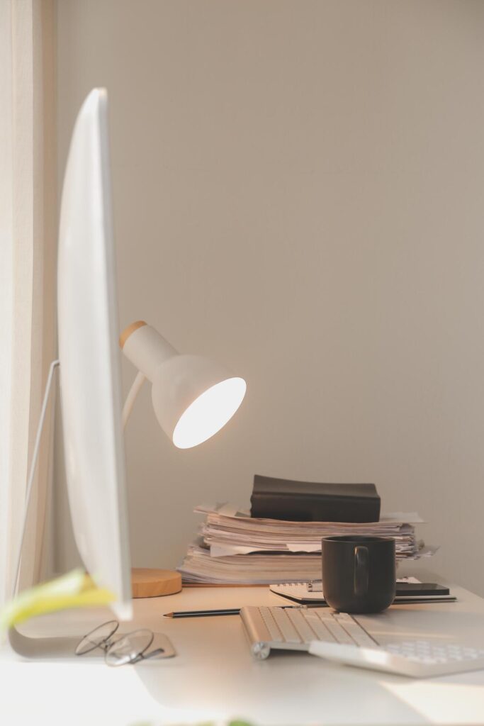 messy office workspace. Messy and cluttered office desk. Messy business office with piles of files and disorganized clutter. Stock Free