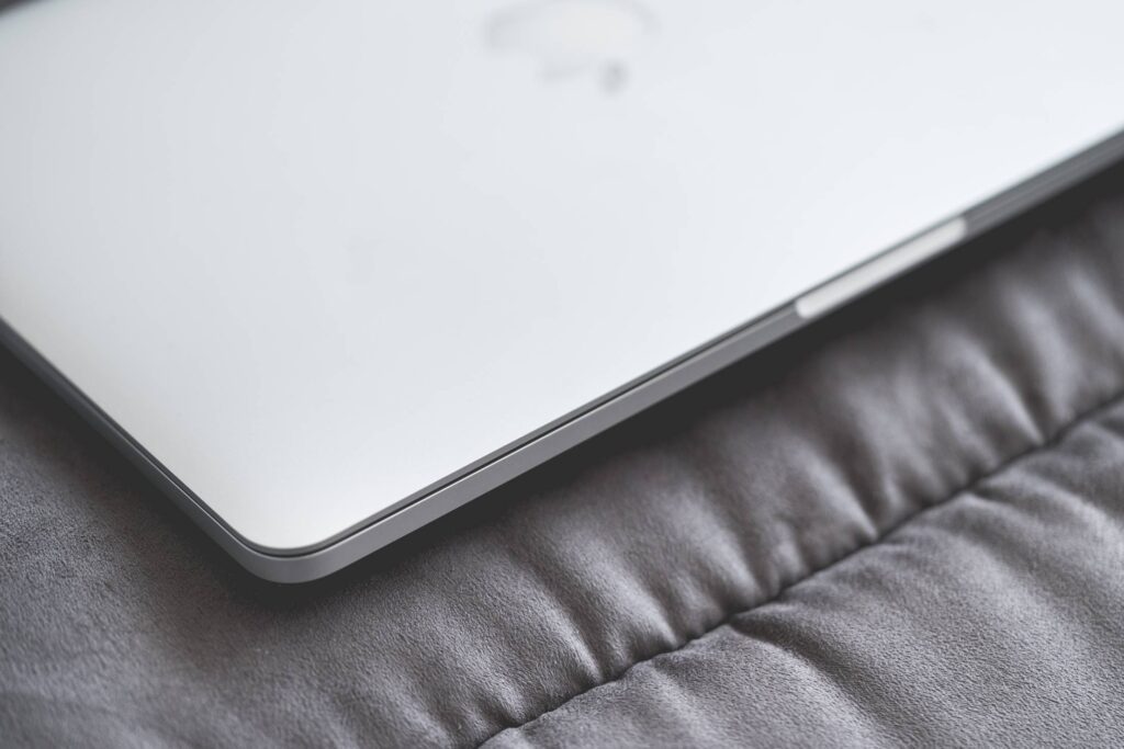 Closed Macbook Laptop on a Sofa #2 Free Photo