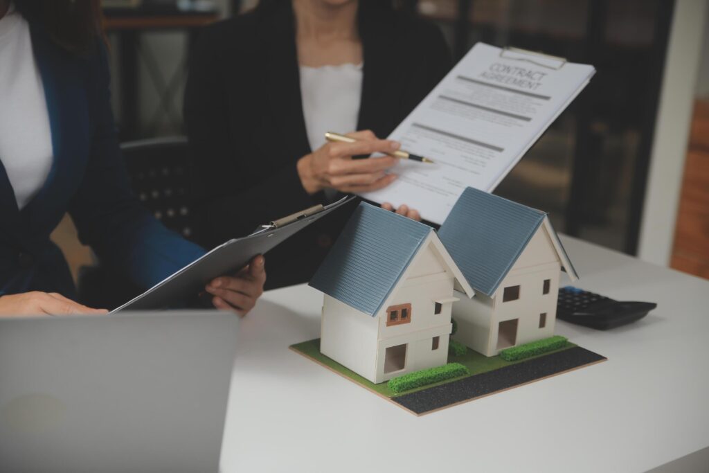 Business Signing a Contract Buy – sell house, insurance agent analyzing about home investment loan Real Estate concept. Stock Free