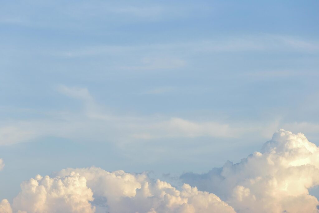 clear blue sky with plain white cloud with space for text background. The vast blue sky and clouds. blue sky background with tiny clouds nature. Stock Free