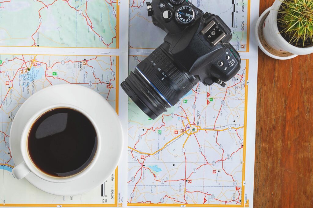 Camera and coffee on a map Stock Free