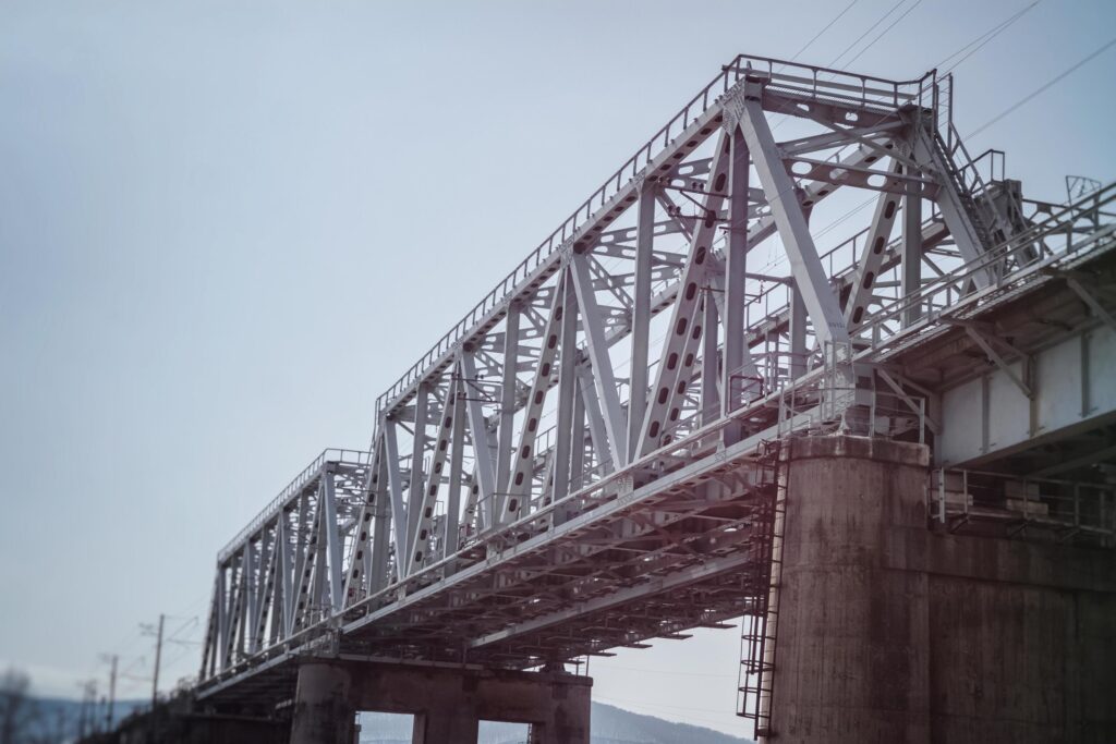 Railway bridge made of metal beams and concrete base. Stock Free