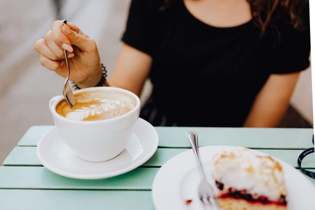 
									Drinking coffee and eating cake in a cafeteria Stock Free