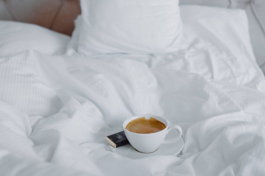 Morning coffee with chocolate in bed Stock Free