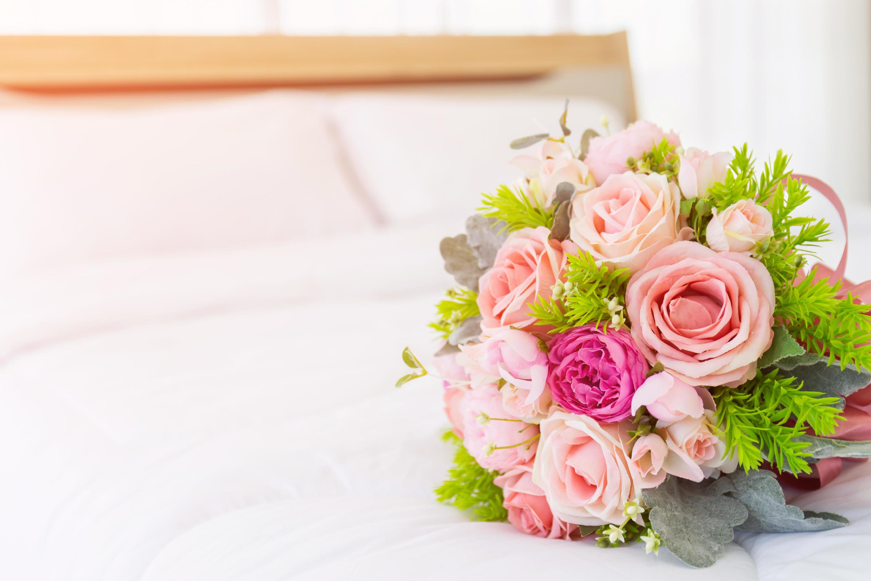 Very beautiful bouquet of flowers laid on a clean white bed. Stock Free