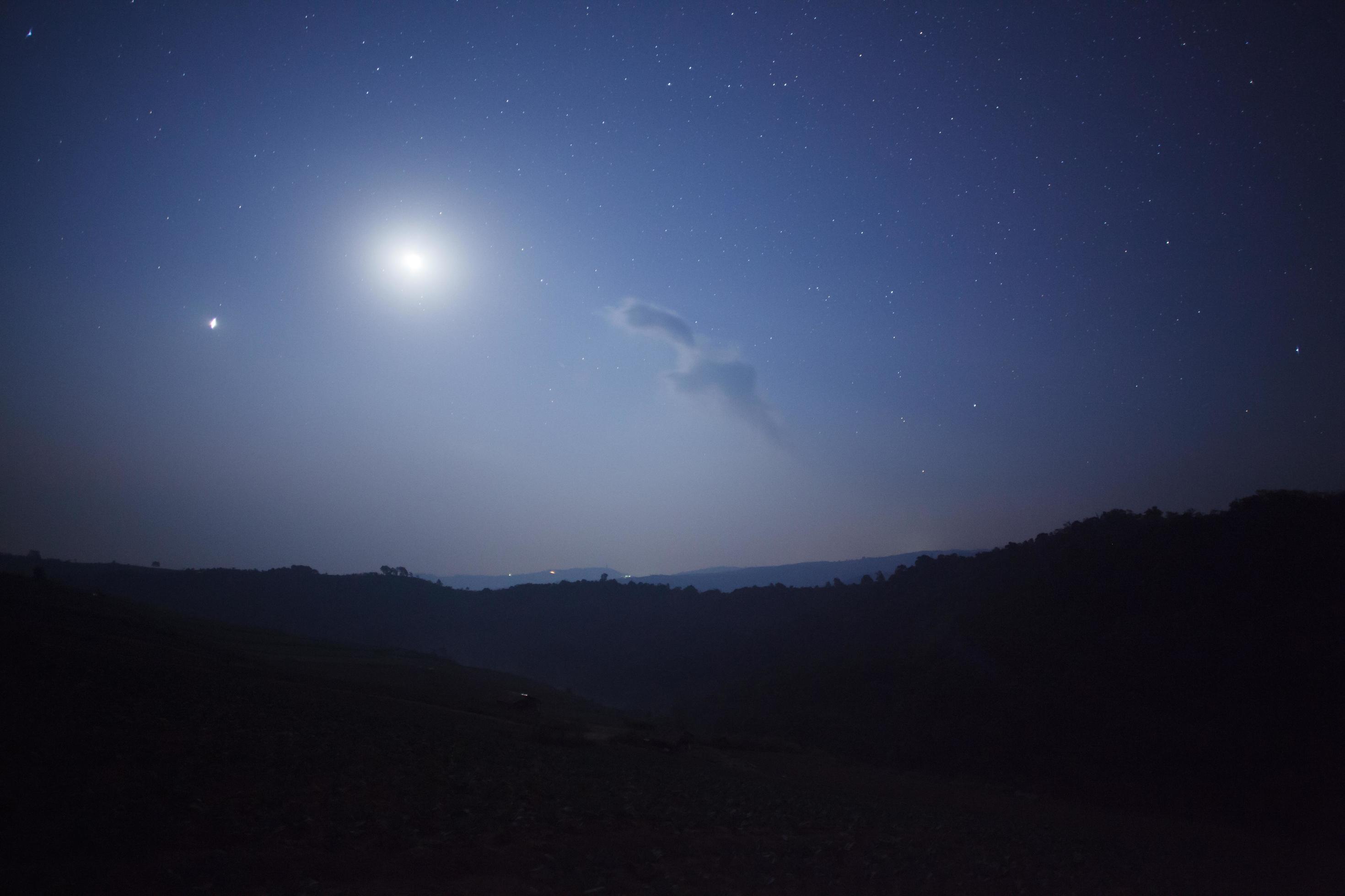 Night nature background, cloudy sky with stars and moon light Stock Free