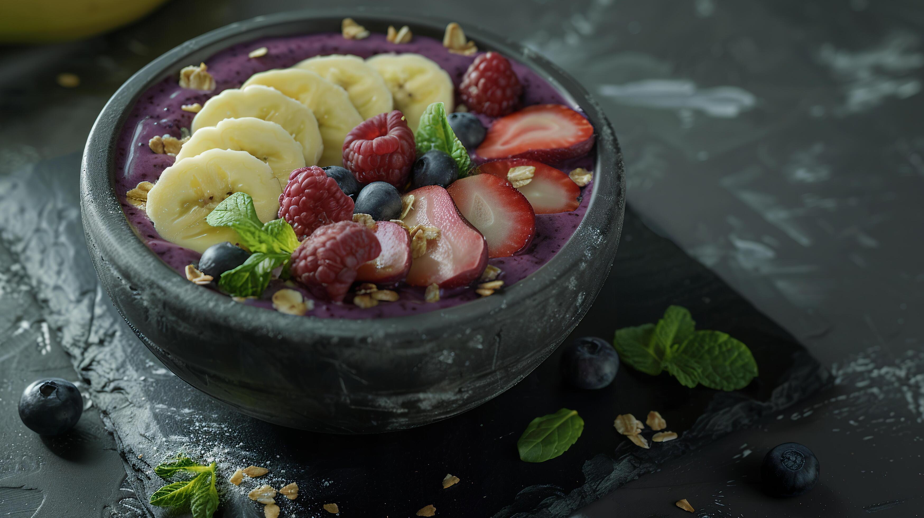 Breakfast smoothie bowl with blended acai, banana, spinach, and almond milk, topped with sliced fruit. Stock Free