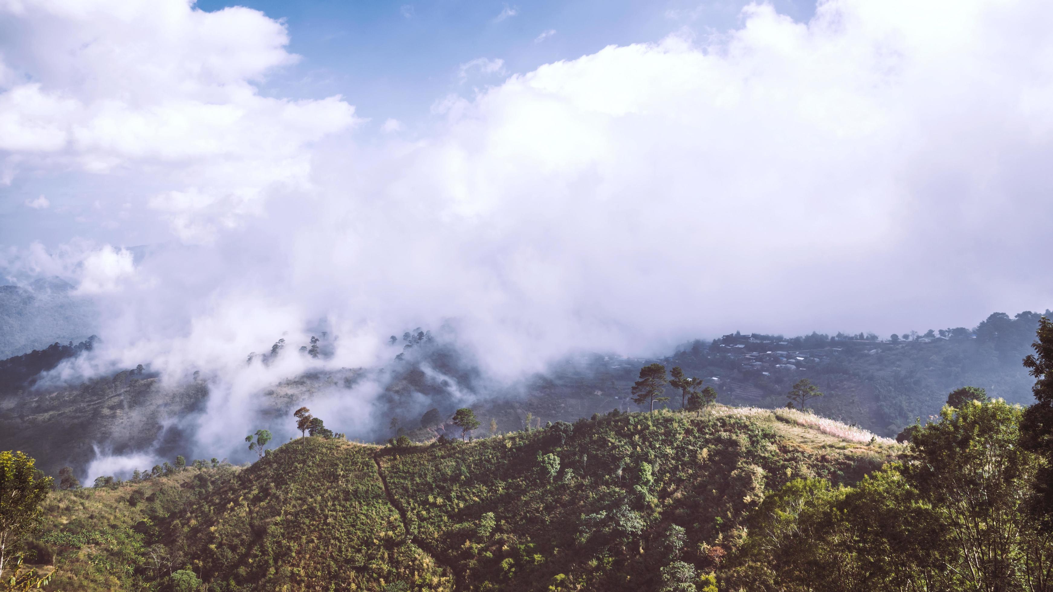 Fog over the mountains.In the rainy weather in the countryside. Filled with green trees and beautiful nature. Stock Free