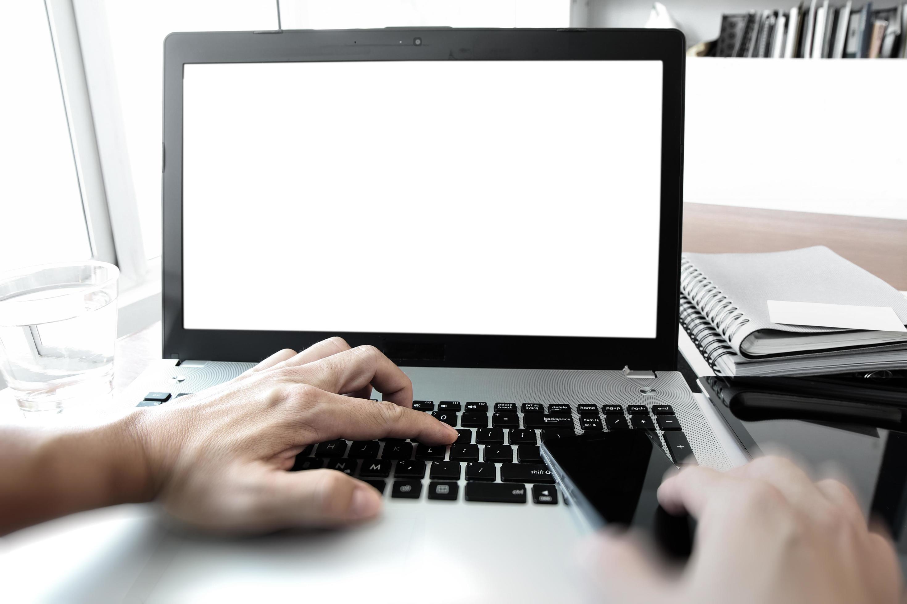 Close up of business man hand working on laptop computer on wooden desk as concept Stock Free