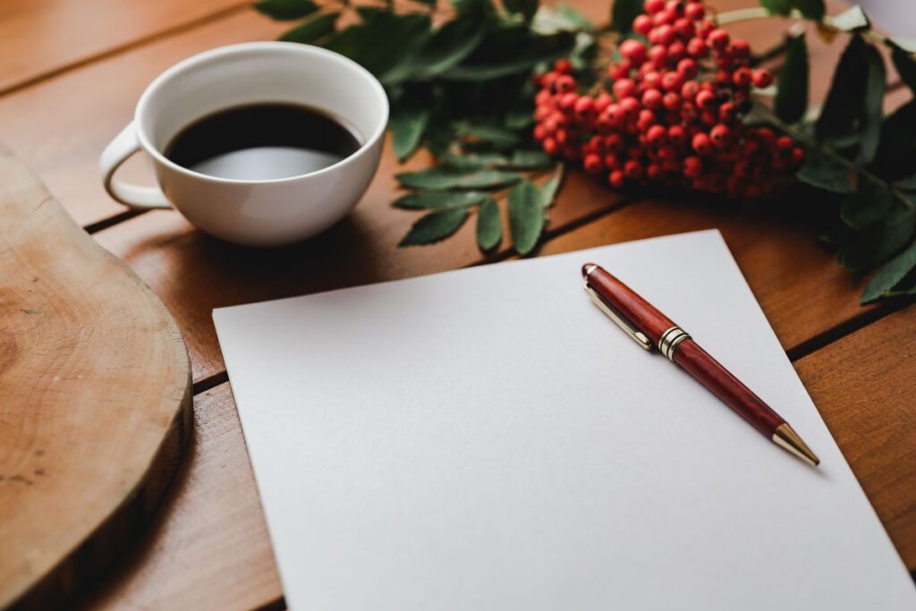 Red rowan fruit with a coffee and a white sheet of paper Stock Free