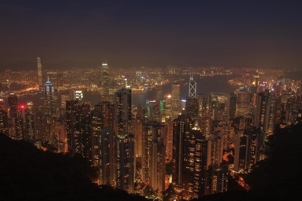 Evening aerial view panorama of Hong Kong skyline and Victoria Harbor. Travel destinations. Stock Free