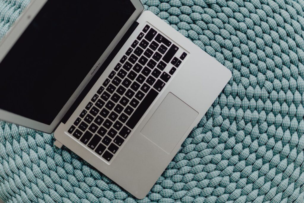 MacBook Laptop on a blue pouf Stock Free