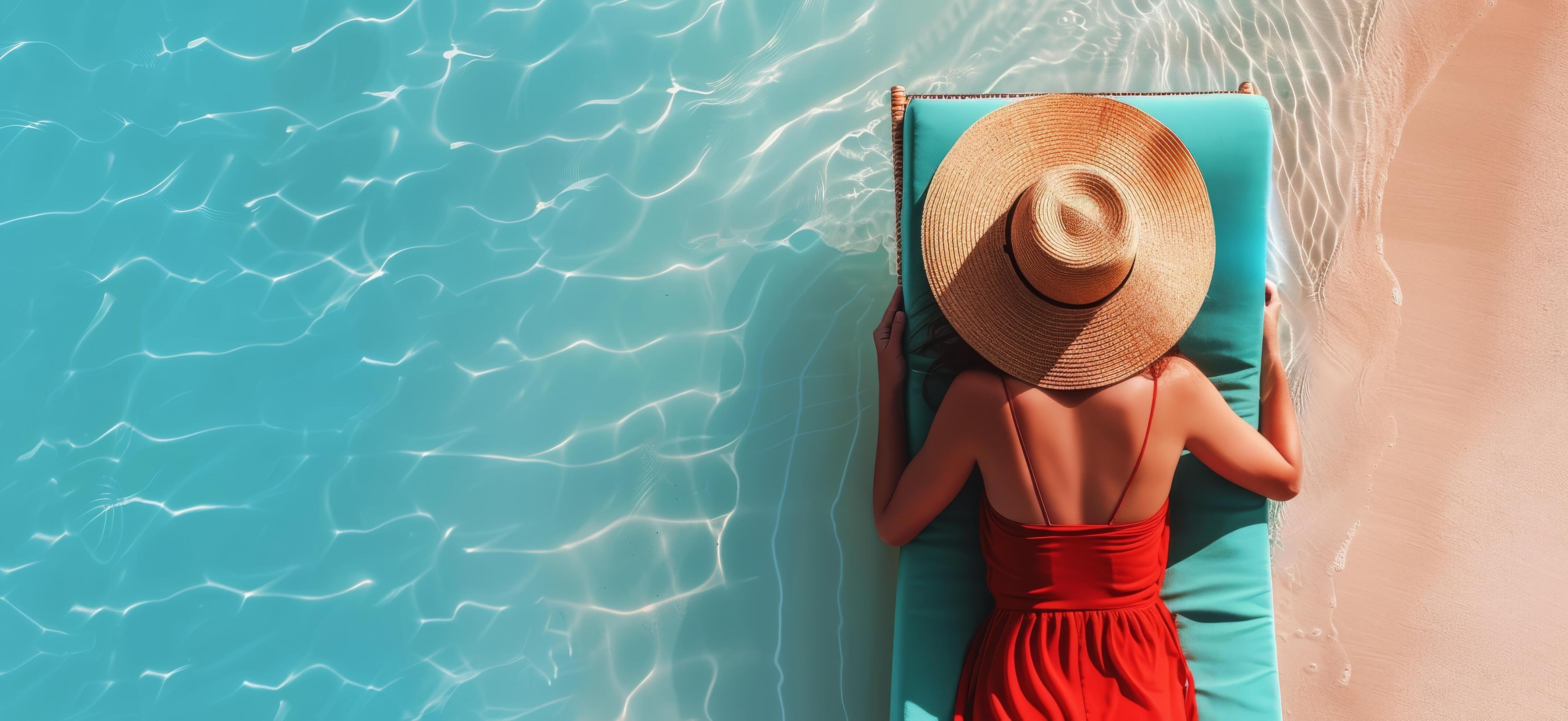 Woman Relaxing on a Blue Lounger by the Pool on a Sunny Day Stock Free