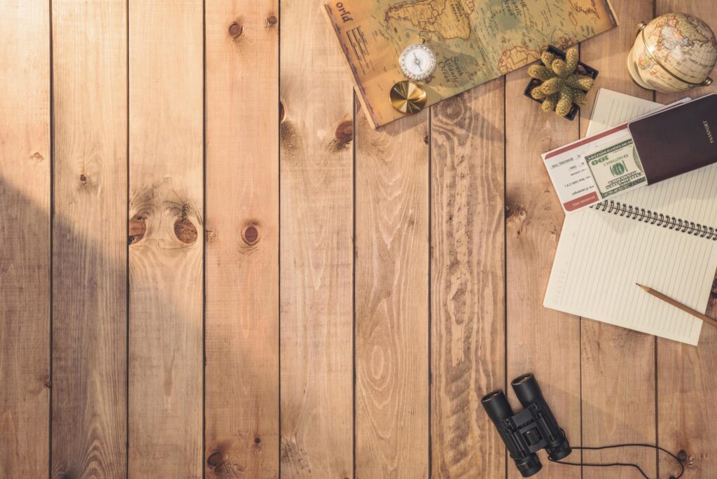 Overhead view of Traveler’s accessories Essential vacation items, and Different objects on wooden background. Travel concept background Stock Free