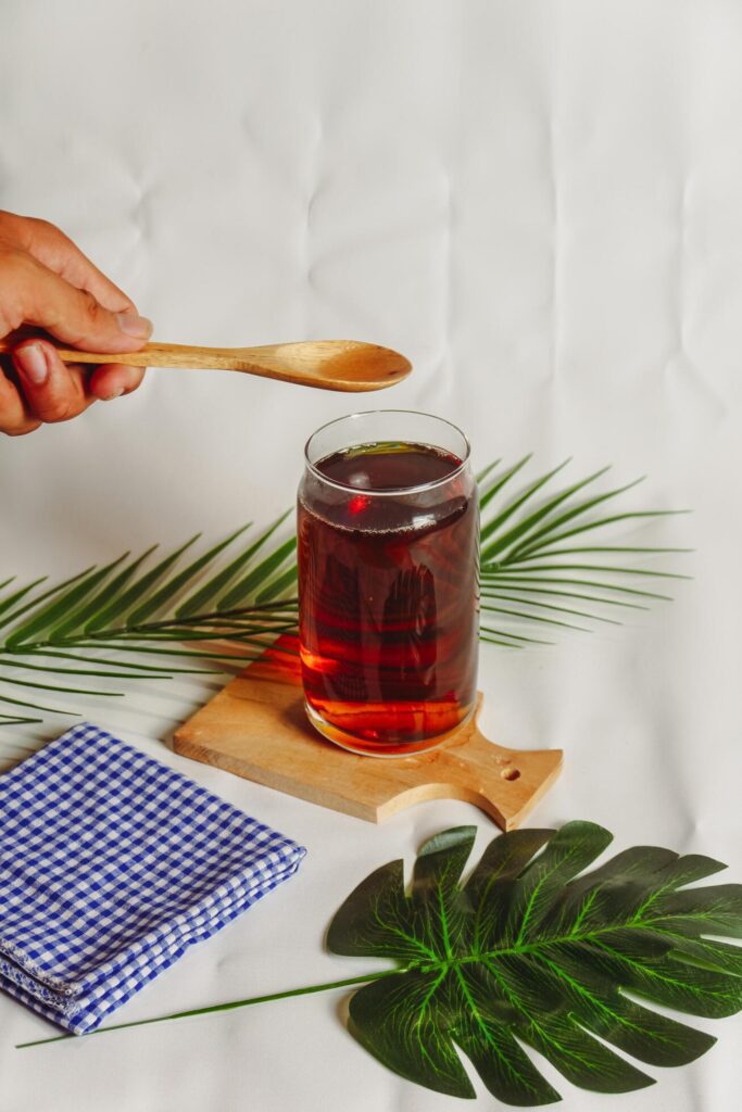 photography of a glass of tea and several elements on a white background Stock Free