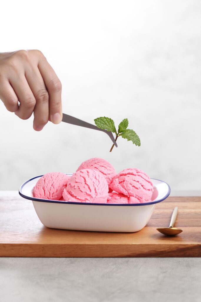 Food stylist use tweezers decorating fake icecream Stock Free