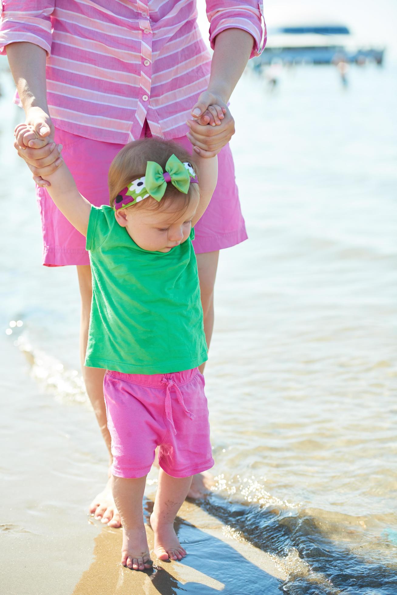 mom and baby on beach have fun Stock Free