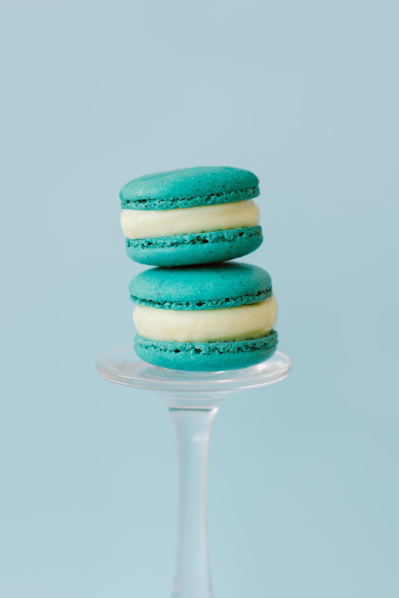 Two French macarons on a light blue background. Mint macarons. Stock Free