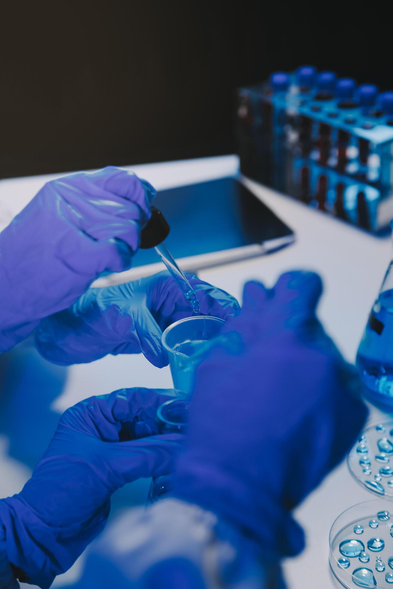 chemist,scientist hand dropping chemical liquid into test tube, science research and development concept Stock Free