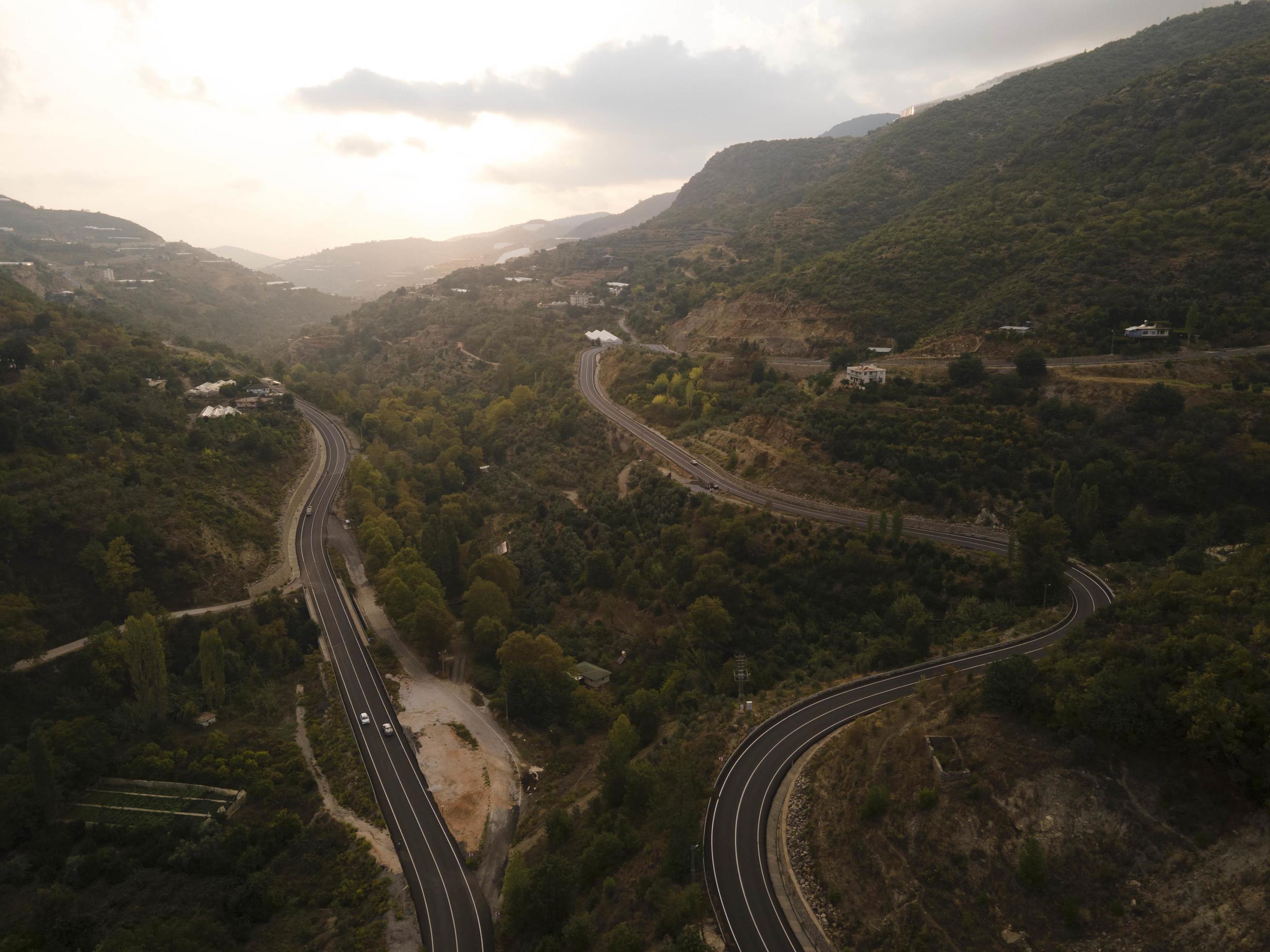 aerial valley and road, Top view, amazing nature background. sunset Flying drone, seascape Stock Free