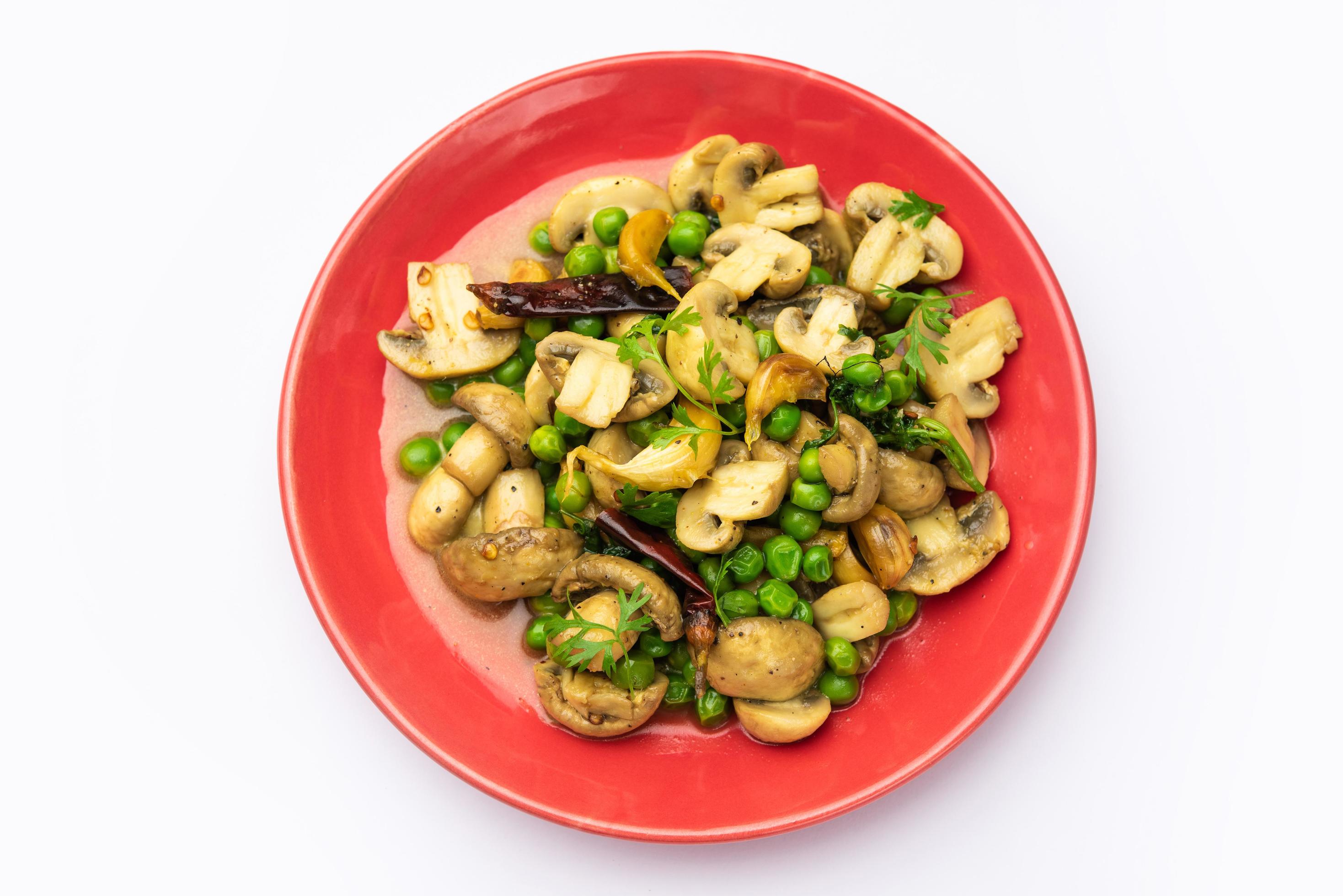 Mushroom and Pea Curry with Roasted Garlic, Indian food served in a bowl Stock Free