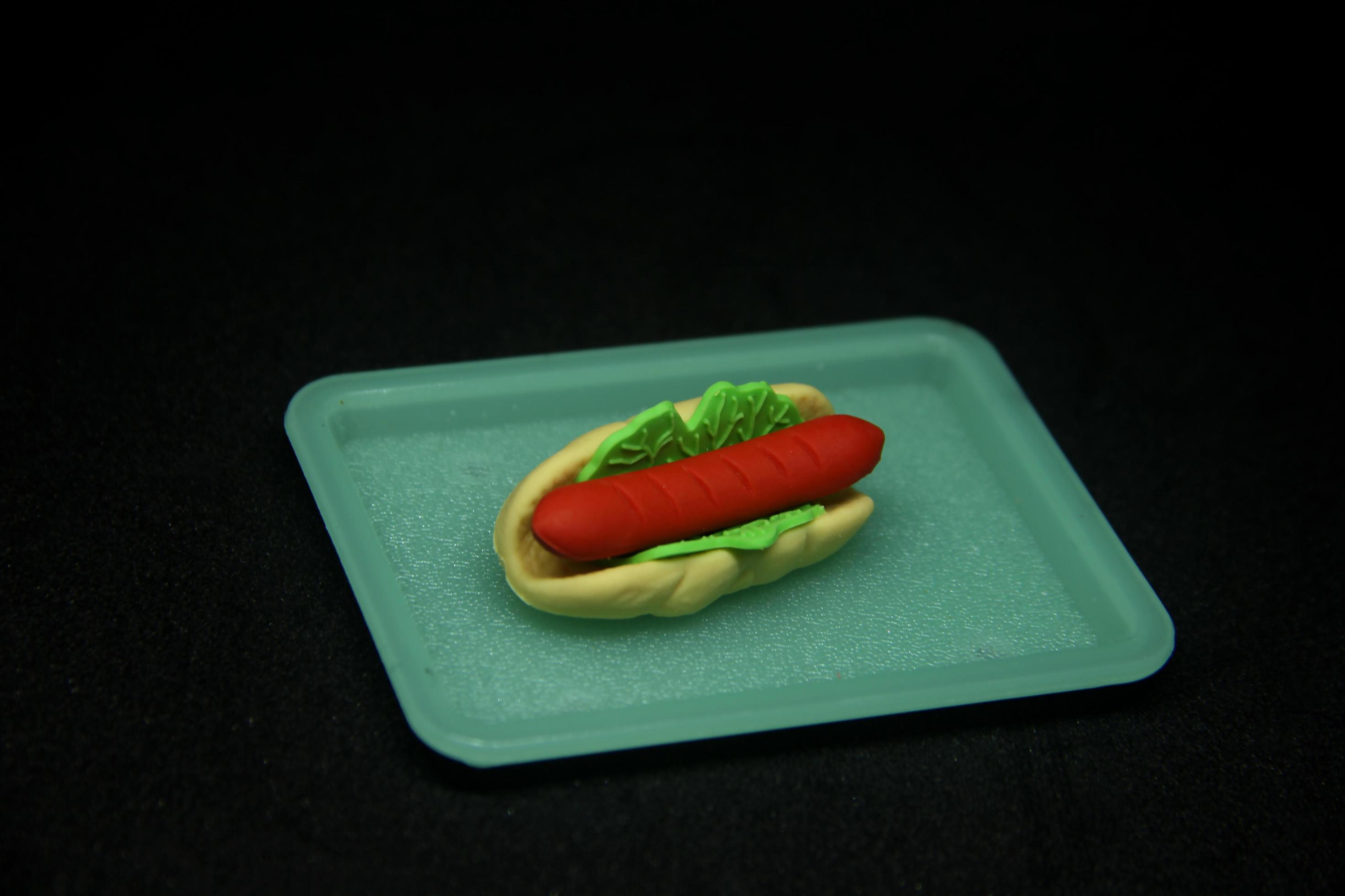 Yummy hot dog shaped eraser. School or office stationary tool supplies with fast food shape. isolated photo on dark black background. Stock Free