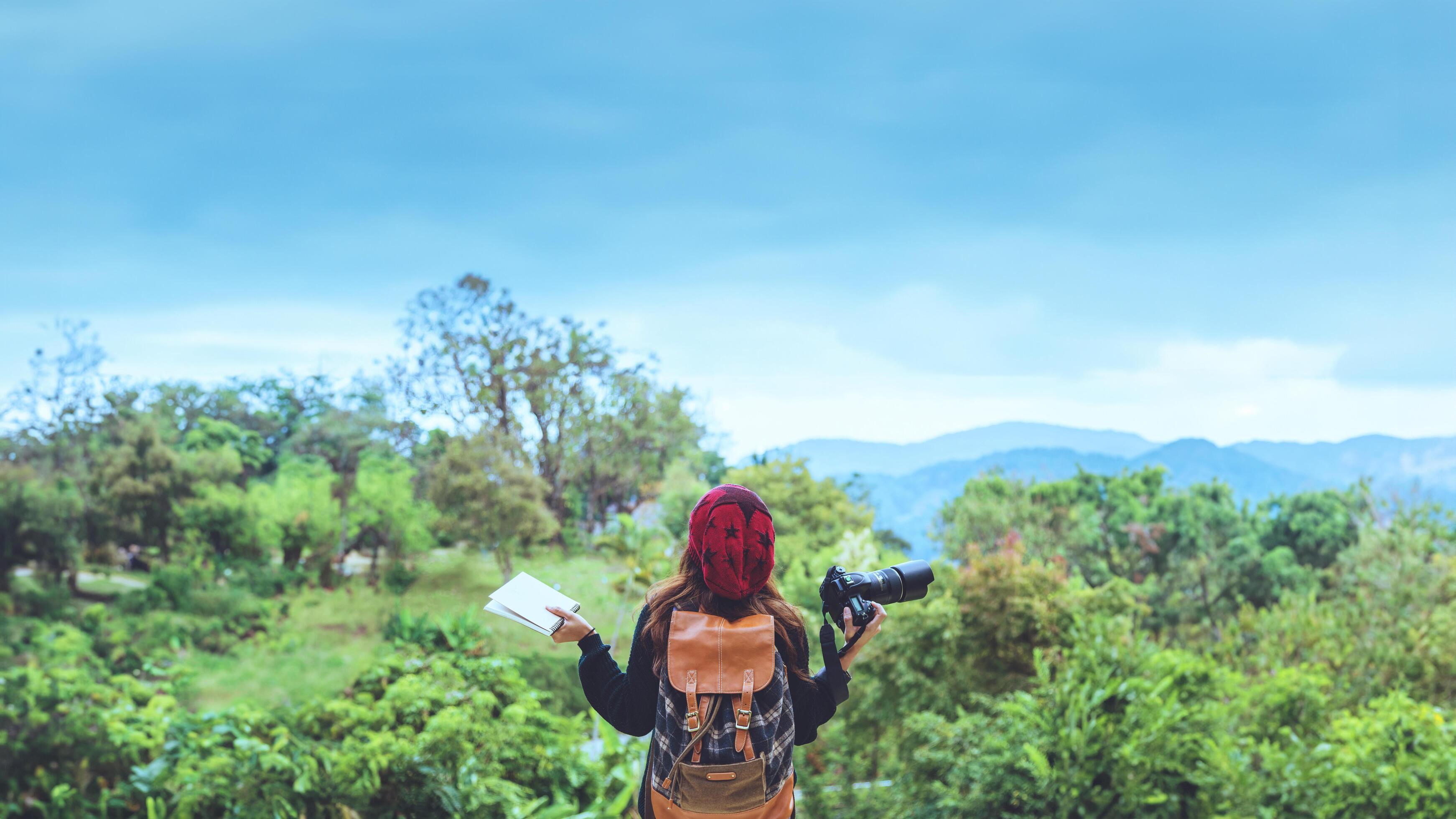 Women travel photograph nature education. nature relax study read a book. at public park in summer. In Thailand Stock Free