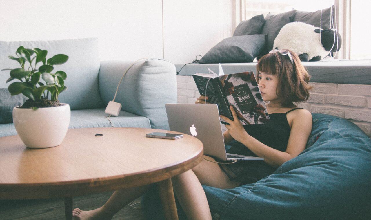 Woman on Beanbag Reading Book Stock Free