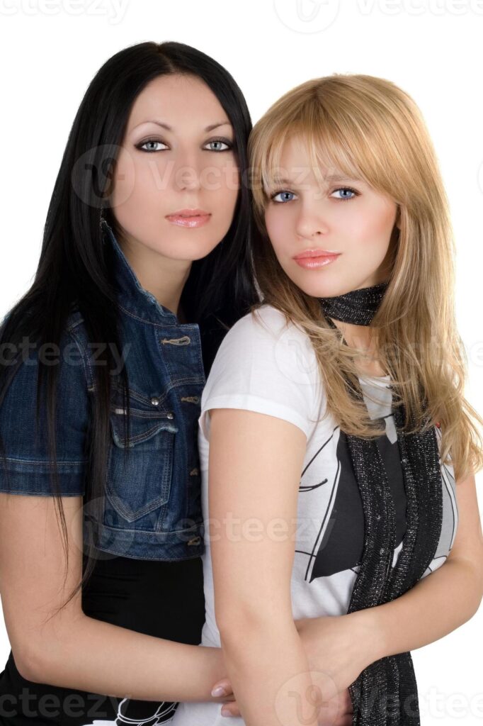 Portrait of the two pretty girlfriends. Isolated on white Pro Photo