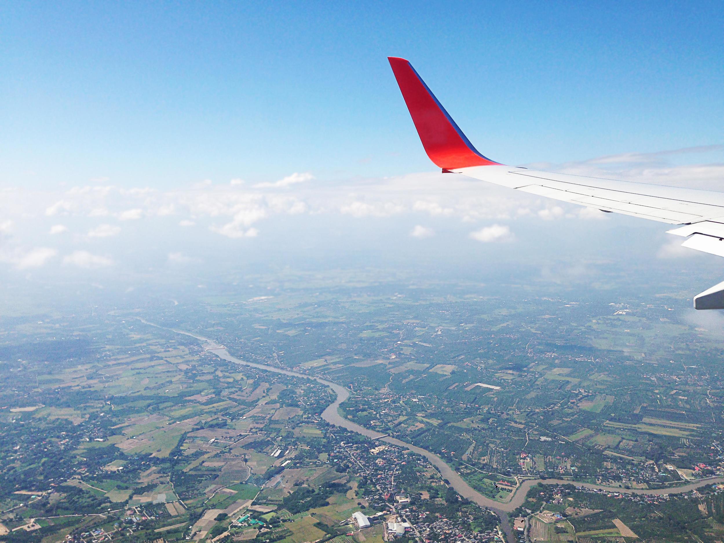 Winglet of airplane in the air during its flight with nice nature sky and landscape scene background Stock Free