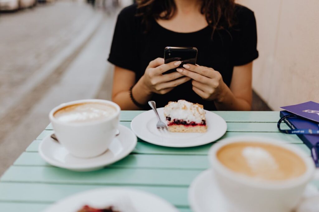 
									Drinking coffee and eating cake in a cafeteria Stock Free