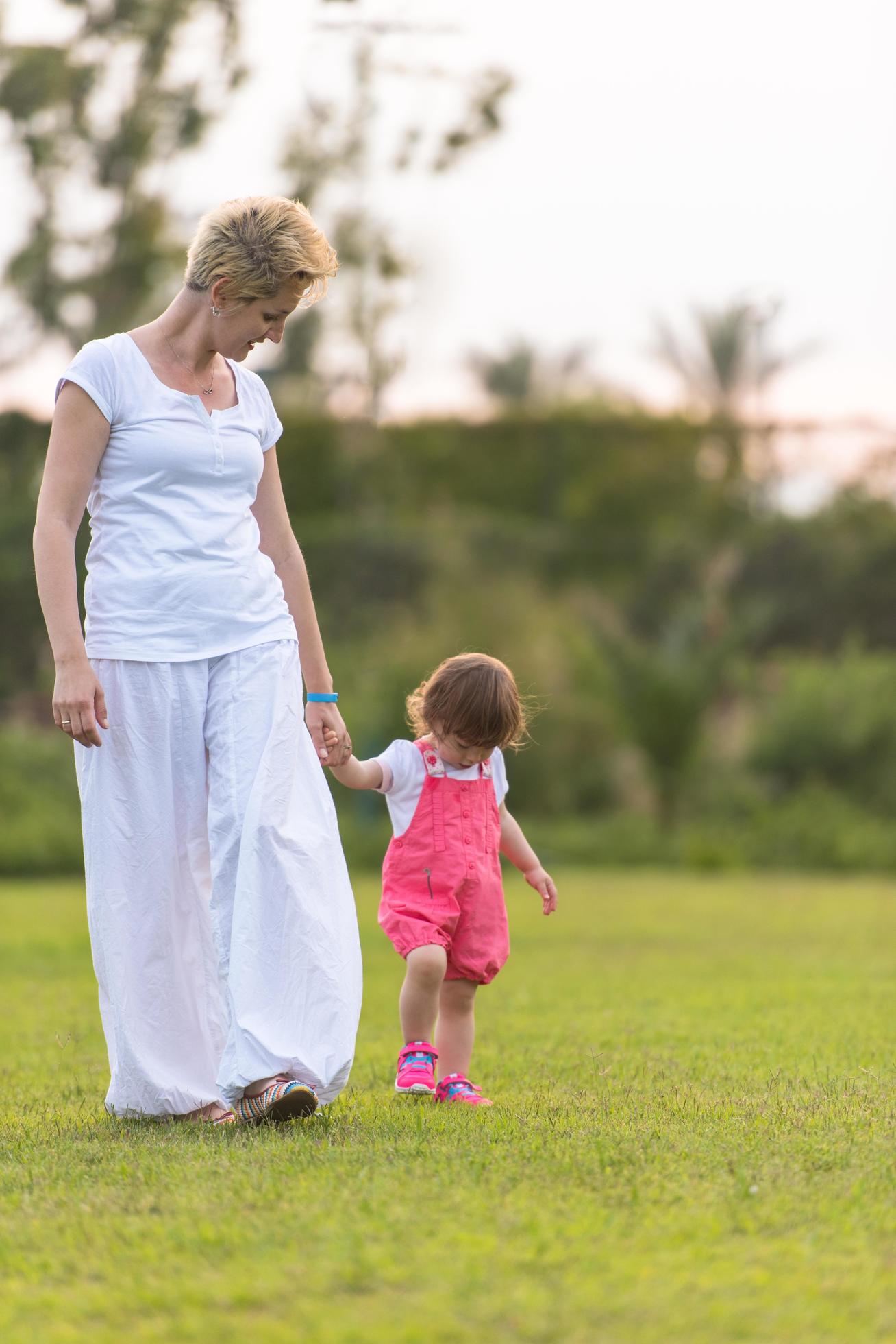 mother and little daughter playing at backyard Stock Free