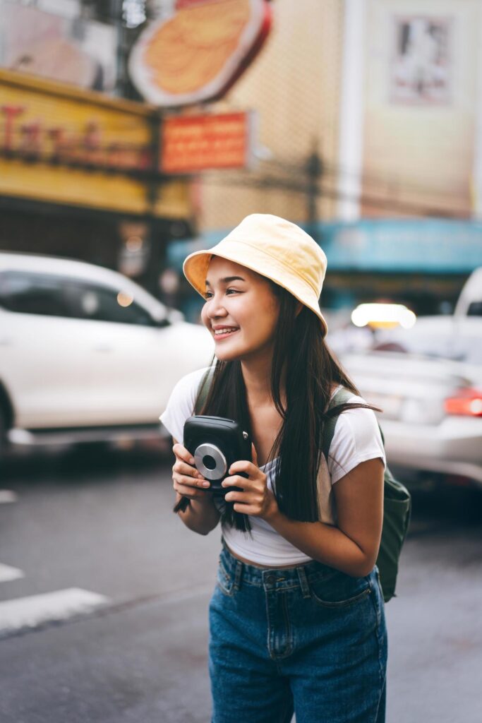 Young asian traveller woman with instant camera in Bangkok, Thailand Stock Free