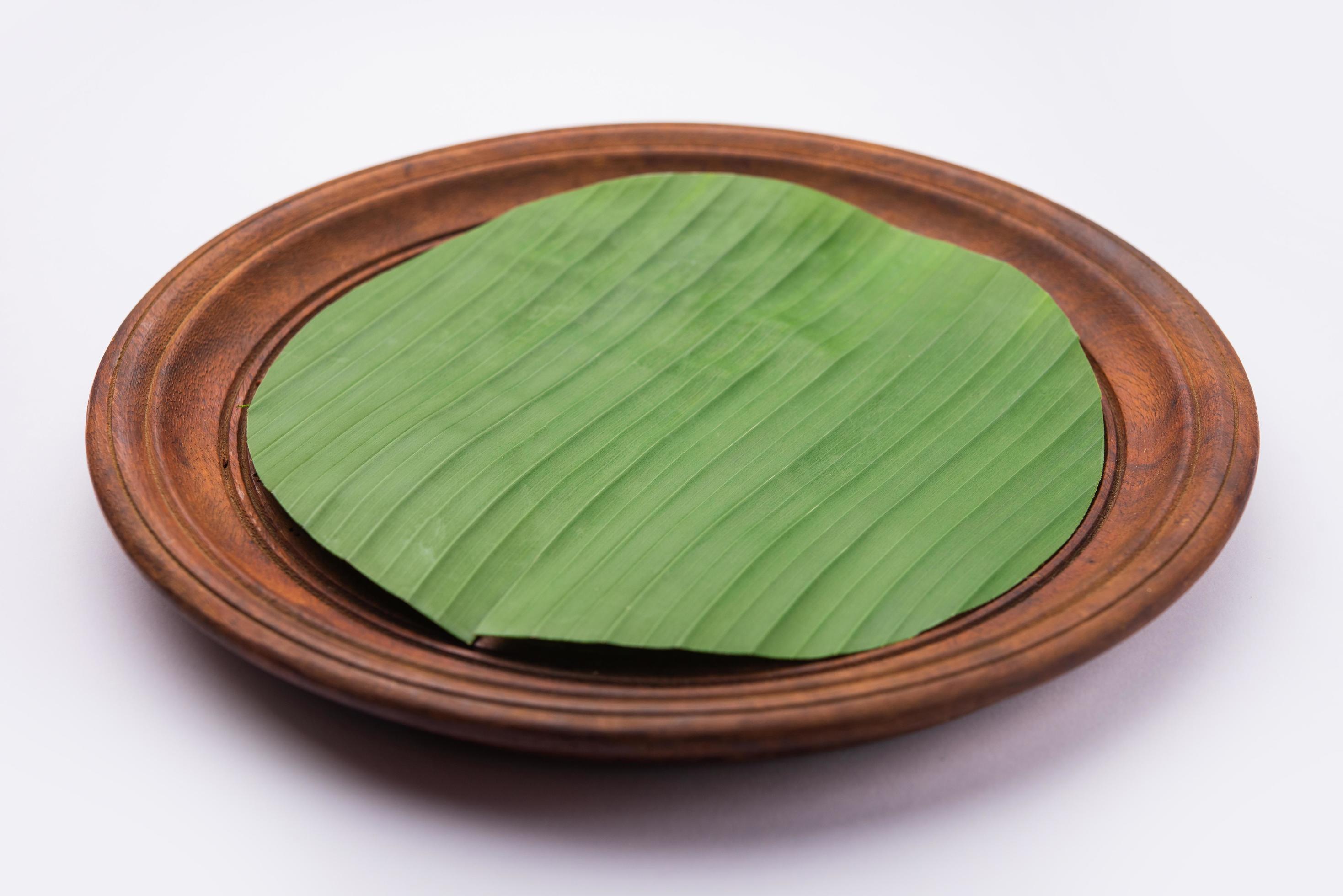 banana leaf on blank plate for edit food or subject on Stock Free