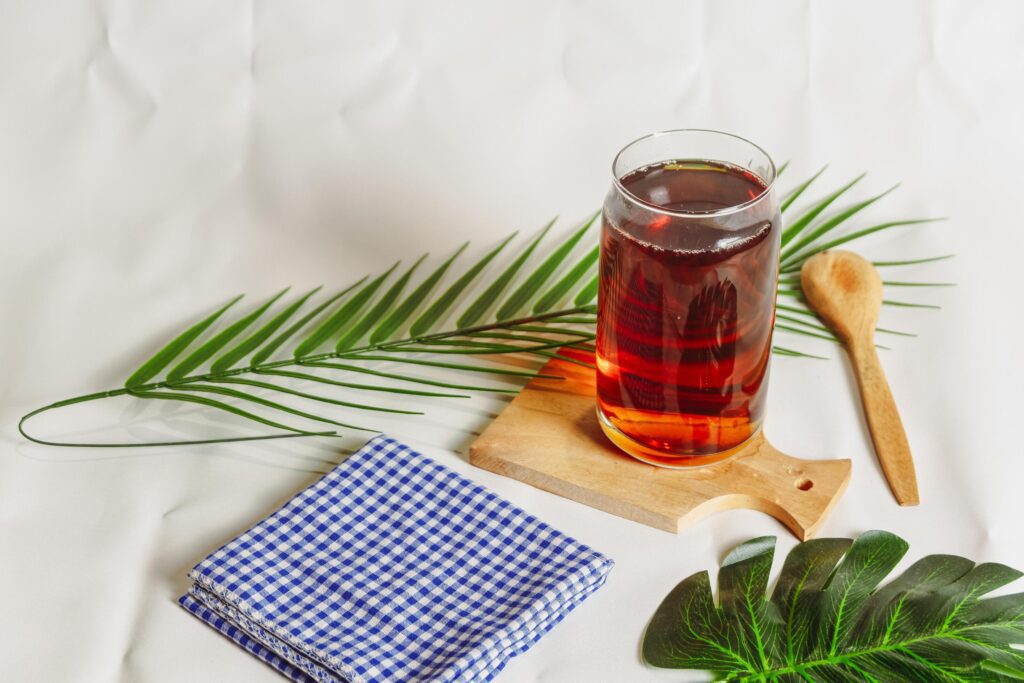 photography of a glass of tea and several elements on a white background Stock Free