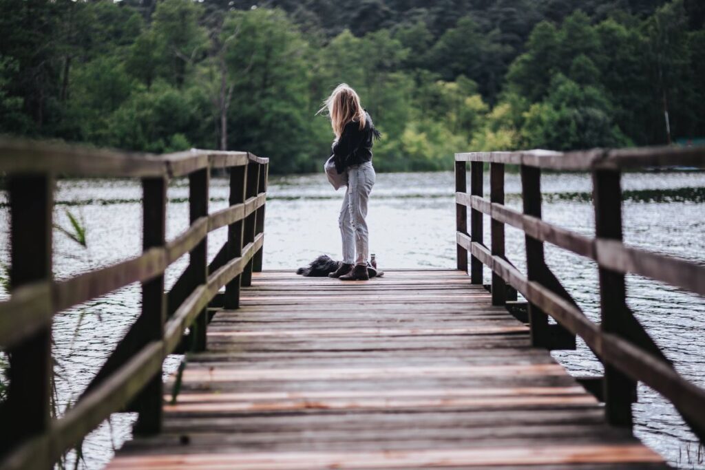 Blonde woman having a healthy snack at the wooden pier Stock Free