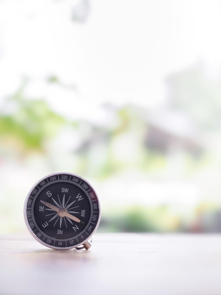 Close up compass on table in the sunset time. The concept of world tourism day, Searching the right directions and Travel Stock Free