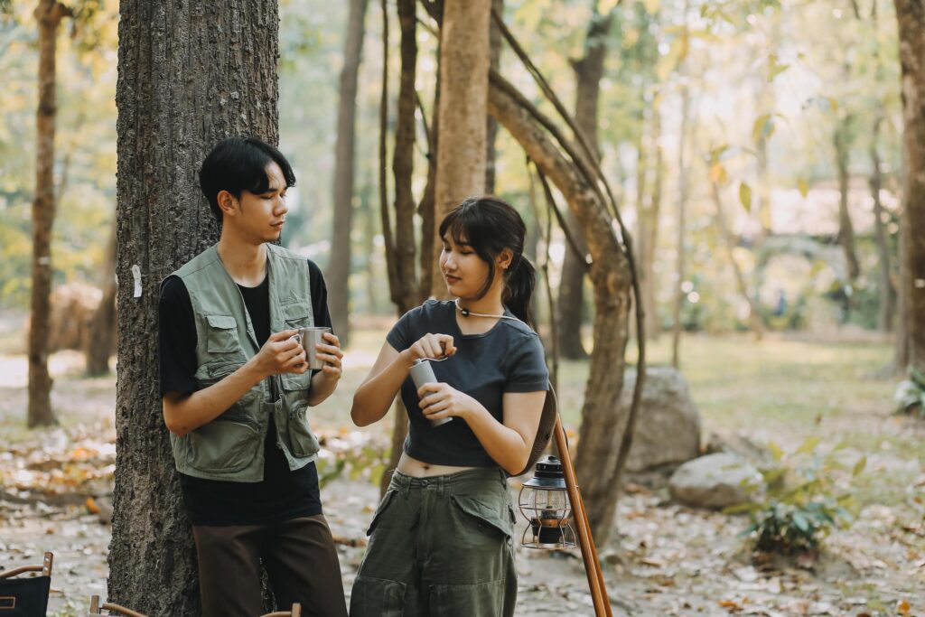 Asian couple sweet in tent inside on they camping trip, traveller relax and sleep togather in out door and camping trip Stock Free